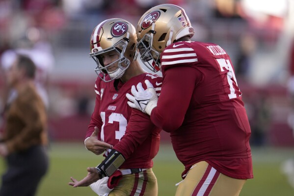 San Francisco 49ers quarterback Brock Purdy (13) is congratulated by offensive tackle Trent Williams after throwing a touchdown pass to wide receiver Brandon Aiyuk during the second half of an NFL football game against the Tampa Bay Buccaneers in Santa Clara, Calif., Sunday, Nov. 19, 2023. (AP Photo/Godofredo A. Vásquez)