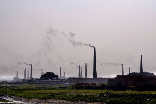 Smoke rises from chimneys of brick kilns on the outskirts of Dhaka, Bangladesh, on Feb. 9, 2025. (AP Photo/Mahmud Hossain Opu)