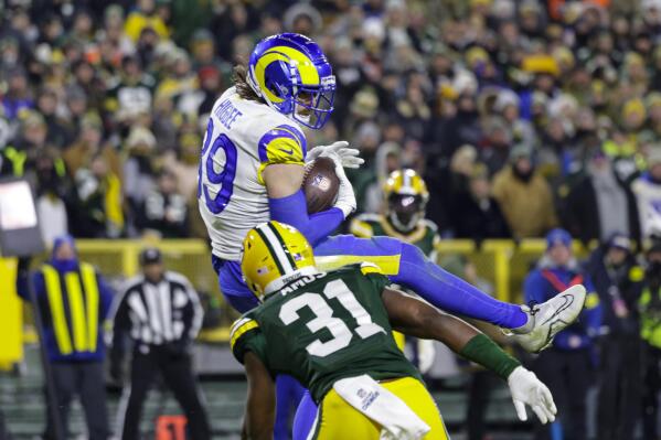 Los Angeles Rams tight end Tyler Higbee (89) makes a catch for a touchdown over Green Bay Packers safety Adrian Amos (31) in the second half of an NFL football game in Green Bay, Wis. Monday, Dec. 19, 2022. (AP Photo/Matt Ludtke)