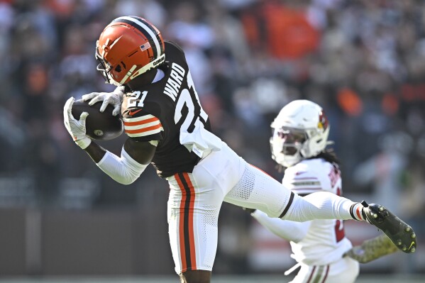 Cleveland Browns cornerback Denzel Ward (21) intercepts a pass against the Arizona Cardinals during the first half of an NFL football game Sunday, Nov. 5, 2023, in Cleveland. (AP Photo/David Richard)