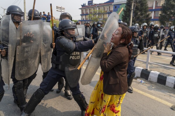 Policemen baton charge supporters of Rastriya Prajatantra Party, or national democratic party during a protest demanding a restoration of Nepal's monarchy in Kathmandu, Nepal, Tuesday, April 9, 2024. Riot police used batons and tear gas to halt thousands of supporters of Nepal's former king demanding the restoration of the monarchy and the nation's former status as a Hindu state. Weeks of street protests in 2006 forced then King Gyanendra to abandon his authoritarian rule and introduce democracy. (AP Photo/Niranjan Shrestha)