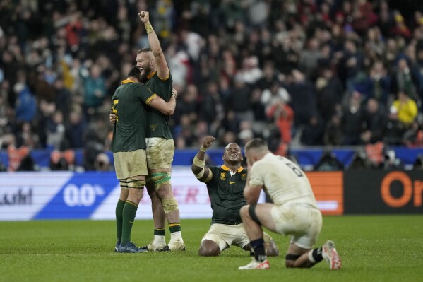 South Africa players celebrate after defeating England 16-15 in the Rugby World Cup semifinal match at the Stade de France in Saint-Denis, outside Paris, Saturday, Oct. 21, 2023. (AP Photo/Lewis Joly)