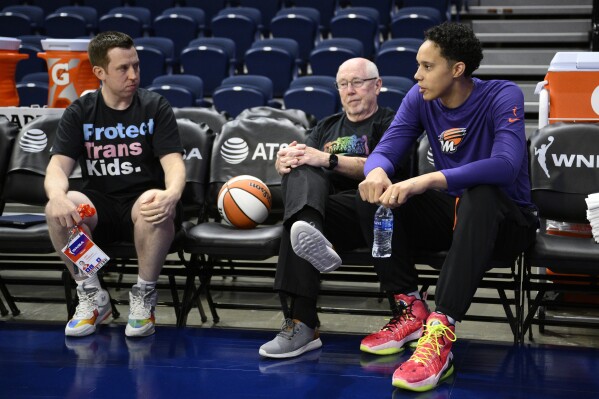Phoenix Mercury center Brittney Griner, right, talks with Washington Mystics coach Eric Thibault, left, and general manager Mike Thibault before a WNBA basketball game Friday, June 16, 2023, in Washington. (AP Photo/Nick Wass)