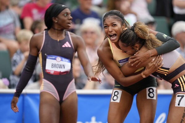 Gabby Thomas celebrates after winning the women's 200-meter final with third place winner McKenzie Long during the U.S. Track and Field Olympic Team Trials Saturday, June 29, 2024, in Eugene, Ore. (AP Photo/George Walker IV)