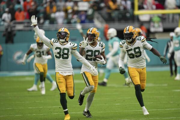 Green Bay Packers cornerback Rasul Douglas (29), center, celebrates making an interception, with teammates Green Bay Packers safety Innis Gaines (38), and Green Bay Packers linebacker De'Vondre Campbell (59), during the second half of an NFL football game, Sunday, Dec. 25, 2022, in Miami Gardens, Fla. (AP Photo/Jim Rassol)