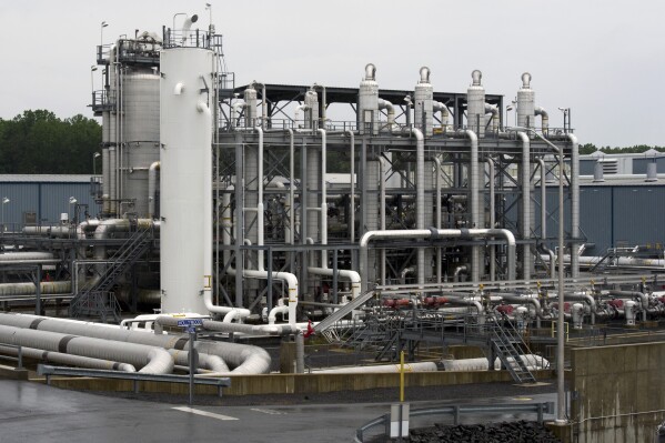 FILE - A heat exchanger and transfer pipes at Dominion Energy's Cove Point LNG Terminal in Lusby, Md., June 12, 2014. The Biden administration is delaying consideration of new natural gas export terminals in the United States, even as gas shipments to Europe and Asia have soared since Russia’s invasion of Ukraine. (AP Photo/Cliff Owen, File)
