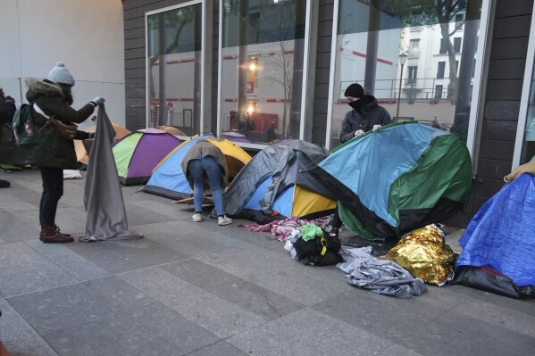 Police clear out a migrant camp in central Paris. Activists say it’s a pre-Olympics sweep