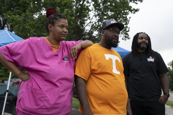 Chloe Isom, left, with Rashaad Woods and Denzel Grant, right, of Turn Up Knox along Martin Luther King Jr. Ave. on Thursday, Aug. 3, 2023, in Knoxville, Tenn. (AP Photo/George Walker IV)