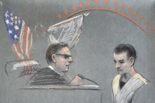 Massachusetts Air National Guardsman Jack Teixeira, right, appears in U.S. District Court in Boston, Friday, April 14, 2023. He is accused in the leak of highly classified military documents as prosecutors unsealed charges and revealed how billing records and interviews with social media comrades helped pinpoint Teixeira. (Margaret Small via AP)