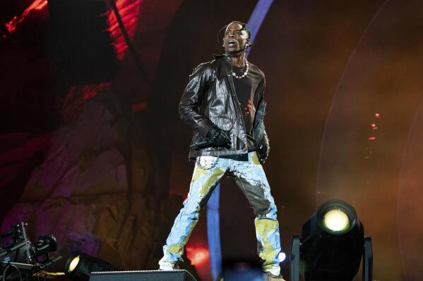 FILE - Travis Scott performs at Day 1 of the Astroworld Music Festival at NRG Park on Friday, Nov. 5, 2021, in Houston. Several families of the 10 people who died from injuries in the crush of fans at the Astroworld festival have turned down an offer by headliner Scott to pay for their loved ones’ funeral costs. (Photo by Amy Harris/Invision/AP, File)