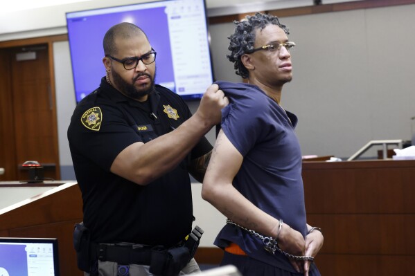 Omar Talley is led out of a courtroom after being disruptive during his sentencing at the Regional Justice Center in Las Vegas, Tuesday, Jan. 30, 2024. Talley who was convicted of fatally shooting two Northern California women near the Las Vegas Strip almost eight years ago has been sentenced to life in prison without the possibility of parole. The Las Vegas Review-Journal reports Talley was sentenced Tuesday after a judge reprimanded him for his lack of remorse. (Bizuayehu Tesfaye/Las Vegas Review-Journal via AP)
