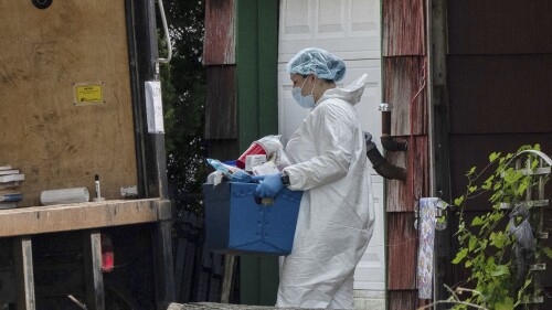 A crime laboratory officer removes a box of items as law enforcement searches the home of Rex Heuermann, Saturday, July 15, 2023, in Massapequa Park, N.Y. Heuermann, a Long Island architect, was charged Friday, July 14, with murder in the deaths of three of the 11 victims in a long-unsolved string of killings known as the Gilgo Beach murders. (AP Photo/Jeenah Moon)