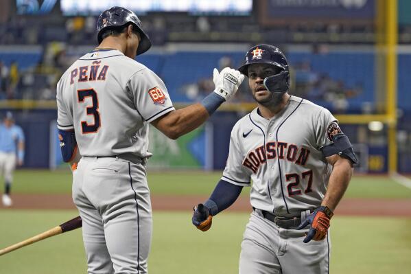 Houston Astros' Jose Altuve (27) celebrates his solo home run off Tampa Bay Rays starting pitcher Drew Rasmussen with Jeremy Pena (3) during the first inning of a baseball game Monday, Sept. 19, 2022, in St. Petersburg, Fla. (AP Photo/Chris O'Meara)