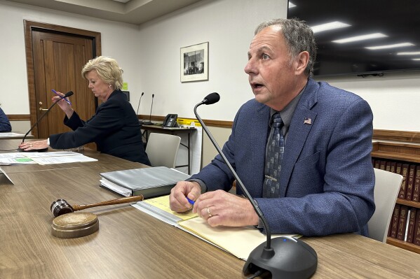 North Dakota Public Service Commission Chairman Randy Christmann, right, begins a meeting of the commission at the state Capitol in Bismarck, N.D., Friday, Sept. 15, 2023. At left is Commissioner Sheri Haugen-Hoffart. The panel, in a 2-1 vote, approved a request by Summit Carbon Solutions to reconsider the commission's Aug. 4 decision to deny a siting permit for the company's proposed 320-mile route in North Dakota. The leg is part of Summit's proposed $5.5 billion, 2,000-mile, five-state pipeline network to carry planet-warming carbon dioxide emissions from 30-some Midwestern ethanol plants to central North Dakota for permanent storage deep underground. (AP Photo/Jack Dura)