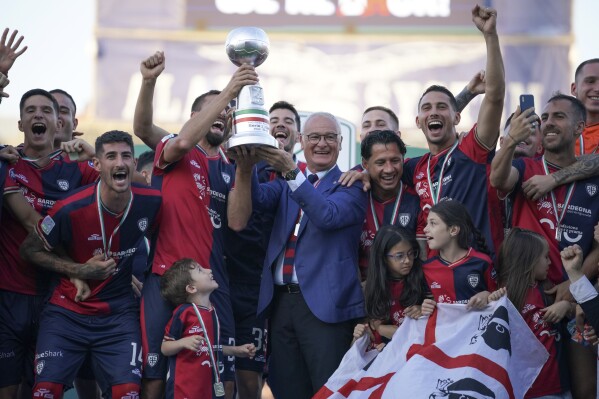 Cagliari coach Claudio Ranieri and his players celebrate being promoted to Serie A on June 8, 2023 at the Unipol Domus Stadium in Cagliari, Italy. (Alessandro Tocco/LaPresse via AP)