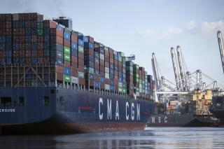 The container ship CMA CGM Laperouse, left, docks at the Georgia Ports Authority's Port of Savannah, Sept. 29, 2021, in Savannah, Ga. The Port of Savannah saw a whopping 20% increase in shipping containers moving across its docks in 2021 as U.S. seaports scrambled to keep up with a surge in cargo that crammed container yards and forced ships to line up and wait at sea. The Georgia Ports Authority reported Tuesday, Jan. 25, 2022 that Savannah's port handled a record 5.6 million container units of imports and exports last year _ an increase of 1 million container units from the 2020 calendar year. (AP Photo/Stephen B. Morton, file)