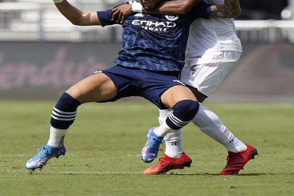 New York City FC midfielder Valentin Castellanos, left, and Inter Miami defender Christian Makoun battle for the ball, Saturday, Oct. 30, 2021, during the first half of an MLS soccer match in Fort Lauderdale, Fla. (AP Photo/Wilfredo Lee)