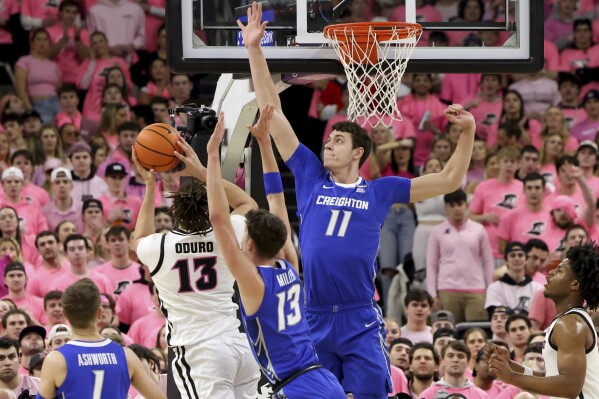 Creighton forward Mason Miller (13) and center Ryan Kalkbrenner (11) defend against Providence forward Josh Oduro (13) during the first half of an NCAA college basketball game Wednesday, Feb. 7, 2024, in Providence, R.I. (AP Photo/Mark Stockwell)