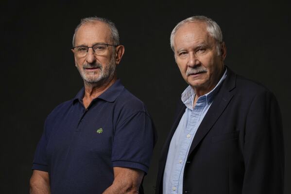 Gustavo Zerbino, left, and writer Pablo Vierci pose for a portrait to promote the film "Society of the Snow" on Friday, Oct. 27, 2023, in Los Angeles. Zerbino is a survivor of a 1972 plane crash in the Andes. (AP Photo/Ashley Landis)