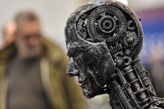 FILE - In this Nov. 29, 2019, file photo, a metal head made of motor parts symbolizes artificial intelligence, or AI, at the Essen Motor Show for tuning and motorsports in Essen, Germany. The Trump administration is proposing new rules guiding how the U.S. government regulates the use of artificial intelligence in medicine, transportation and other industries. The White House unveiled the proposals Tuesday, Jan. 7, and said they're meant to promote private sector applications of AI that are safe and fair. (AP Photo/Martin Meissner, File)
