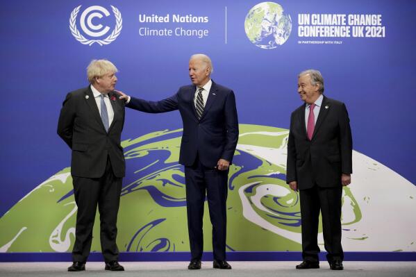 British Prime Minister Boris Johnson, left, and UN Secretary-General Antonio Guterres, right, greet U.S. President Joe Biden , at the COP26 U.N. Climate Summit in Glasgow, Scotland, Monday, Nov. 1, 2021. The U.N. climate summit in Glasgow gathers leaders from around the world, in Scotland's biggest city, to lay out their vision for addressing the common challenge of global warming. (Christopher Furlong/Pool via AP)