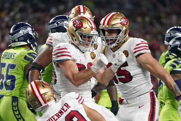 San Francisco 49ers running back Christian McCaffrey (23) reacts after scoring a touchdown during the first half of an NFL football game against the Seattle Seahawks, Thursday, Nov. 23, 2023, in Seattle. (AP Photo/Lindsey Wasson)
