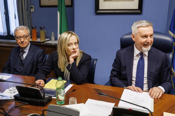 FILE - Italian Premier Giorgia Meloni, center, waits to start her briefing to COPASIR parliamentary intelligence commission in Rome, Thursday, April 13, 2023. At left is, Delegate Authority for the Security of the Republic Alfredo Mantovano, and at right is COPASIR President and opposition lawmaker Lorenzo Guarini. Milan prosecutors say there is no evidence of Russian secret services involvement in the escape from Italian custody of a Russian businessman wanted by the U.S. on sanctions-busting charges. Prosecutors on Wednesday, Dec. 6, 2023 said two suspects have been arrested, one in northern Italy and another in Croatia. (Roberto Monaldo/LaPresse via 鶹ýapp, File)