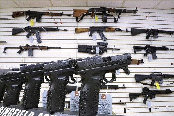 FILE - Semi-automatic guns are displayed for sale at Capitol City Arms Supply, Jan. 16, 2013, in Springfield, Ill. Illinois will soon outlaw advertising for firearms that officials determine produces a public safety threat or appeals to children, militants or others who might later use them illegally, as the state continues its quest to curb mass shootings. (AP Photo/Seth Perlman, File)