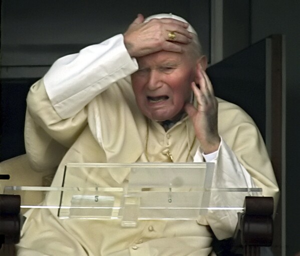 Pope John Paul II appears at a window of his rooms of the 10th floor of Rome's Gemelli Polyclinic Hospital, Sunday, March 13, 2005. (AP Photo/Andrew Medichini, File)