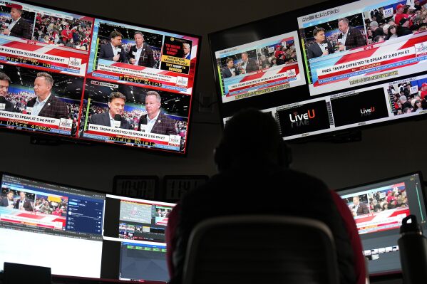 Tyler, a director at Right Side Broadcasting Network in Opelika, Ala., works as Republican presidential candidate former President Donald Trump speaks at a campaign rally in North Carolina on Saturday, March 2, 2024. (AP Photo/Mike Stewart)