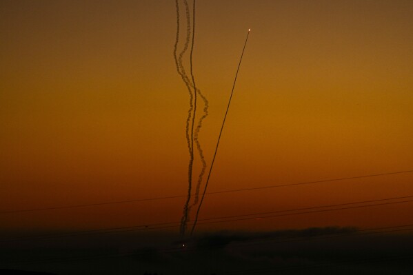 Rockets are fired toward Israel from the Gaza Strip, as seen from southern Israel, Friday, Dec. 15, 2023. (AP Photo/Ariel Schalit)