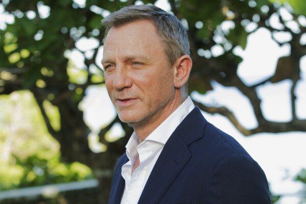 FILE - In this April 25, 2019, file photo, actor Daniel Craig poses for photographers during the photo call of the latest installment of the James Bond film franchise, currently known as "Bond 25," in Oracabessa, Jamaica. An explosion Tuesday, June 4, 2019, on the set of the new James Bond movie has injured one crew member and damaged a stage at Pinewood Studios outside London. No one was injured on set but a crew member outside the stage sustained a minor injury. The exterior of a stage was also damaged at the studio facilities. (AP Photo/Leo Hudson, File)