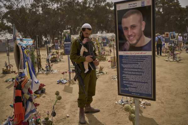 An Israeli soldier walks at the site of Oct. 7, 2023, attack by Hamas militants at the Nova music festival near Kibbutz Reim, southern Israel, April 30, 2025. (AP Photo/Ohad Zwigenberg, File)
