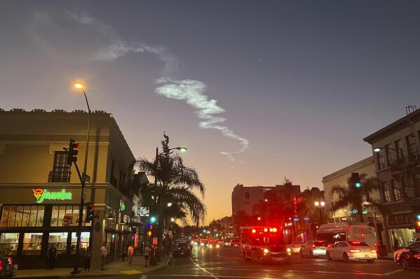 The contrail of a SpaceX Falcon 9 rocket is seen in the sky, from Pasadena, after launching from Vandenberg Space Force Base, Calif., carrying 53 Starlink satellites into orbit, Thursday, Oct. 27, 2022. (AP Photo/John Antczak)