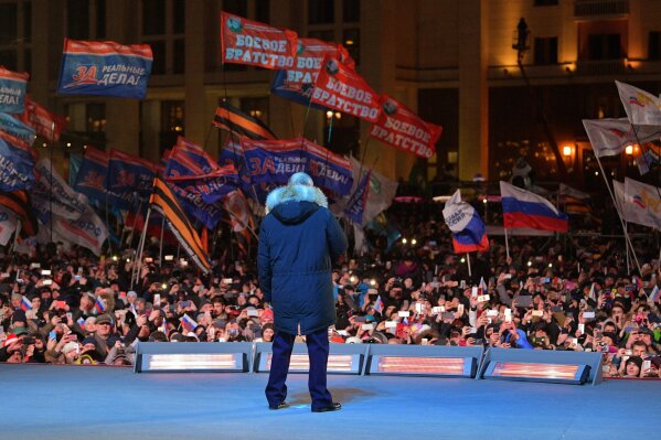 
              Russian President Vladimir Putin speaks to supporters during a rally near the Kremlin in Moscow, Sunday, March 18, 2018. Vladimir Putin headed to an overwhelming win in Russia's presidential election Sunday, adding six years in the Kremlin for the man who has led the world's largest country for all of the 21st century. (Alexei Druzhinin, Sputnik, Kremlin Pool Photo via AP)
            