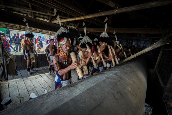 Indigenous Naga tribals dance beat a log drum the Hornbill Festival in Kisama, on the outskirts of Kohima, capital of the northeastern Indian state of Nagaland, Tuesday, Dec. 10, 2024. (AP Photo/Anupam Nath)