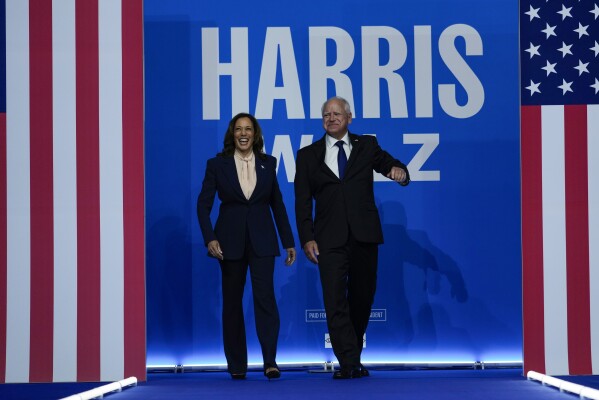 Democratic presidential nominee Vice President Kamala Harris and her running mate Minnesota Gov. Tim Walz arrive at a campaign rally in Philadelphia, Tuesday, Aug. 6, 2024. (AP Photo/Matt Rourke)