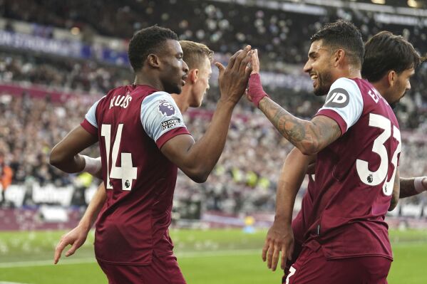West Ham United's Mohammed Kudus, left, celebrates scoring with teammates during the English Premier League soccer match between West Ham United and Wolverhampton Wanderers at the London Stadium, London, Sunday Dec. 17, 2023. (Mike Egerton/PA via AP)