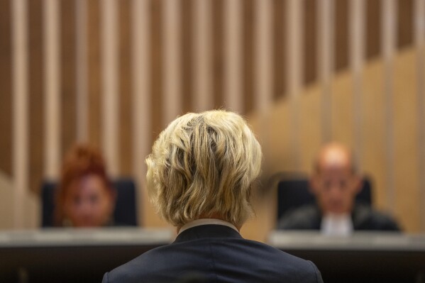 Firebrand anti-Islam lawmaker Geert Wilders listened as presiding judge Verbeek, rear right, delivered the court's verdict against a former Pakistan cricketer accused of incitement to kill, at the high security court building near Schiphol airport, Monday, Sept. 11, 2023. The suspect, identified by Wilders as Khalid Latif, is accused of offering a bounty of some 21,000 euros ($23,000) to anybody who killed Wilders. Prosecutors haven't named Latif. However, in a statement they say a video posted online in 2018 shows a famous Pakistan cricketer offering a bounty for killing Wilders. (AP Photo/Peter Dejong)