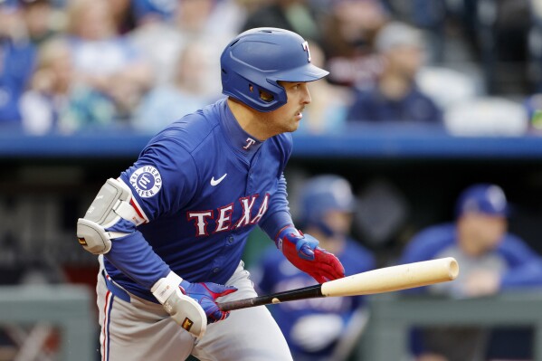 Texas Rangers' Nathaniel Lowe watches his two-run single during the fourth inning of a baseball game against the Kansas City Royals in Kansas City, Mo., Saturday, May 4, 2024. (AP Photo/Colin E. Braley)