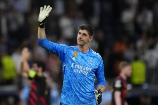 FILE - Real Madrid goalkeeper Thibaut Courtois waves to fans at the end of the Champions League semifinal first leg soccer match between Real Madrid and Manchester City at the Santiago Bernabeu stadium in Madrid, Spain, on May 9, 2023. Courtois has sustained another serious knee injury, just as he was close to returning from a torn ACL. Madrid said Courtois ruptured the meniscus in his right knee during Tuesday, March 19, 2024 training session. (AP Photo/Manu Fernandez, File)