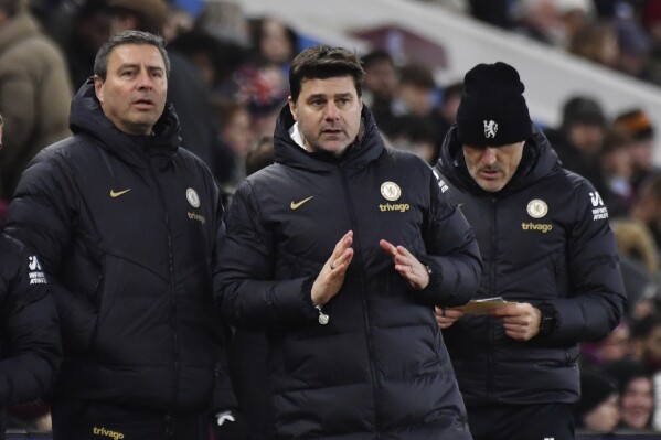 Chelsea's head coach Mauricio Pochettino, centre, stands during the English FA Cup fourth round soccer match between Aston Villa and Chelsea at the Villa Park Stadium in Birmingham, England, Wednesday, Feb. 7, 2024. (AP Photo/Rui Vieira)