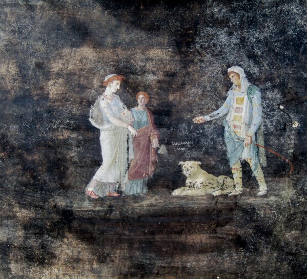 This image released by the Italian Culture Ministry on Wednesday, April 10, 2024, shows a fresco depicting the Greek mythology's figures of Helen, left, and Paris of Troy, right, inside an imposing banquet hall, with elegant black walls, decorated with mythological subjects inspired by the Trojan War, recently unhearted in the Pompeii archaeological area near Naples in southern Italy. (Italian Culture Ministry via AP, HO)