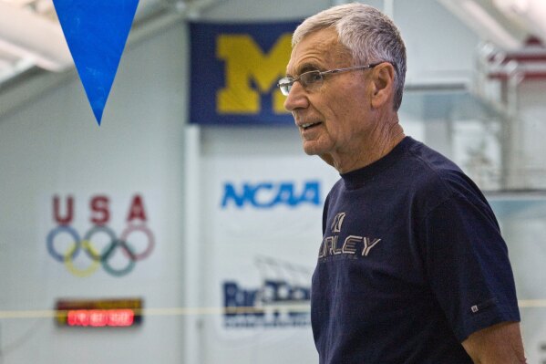 FILE - Retired University of Michigan coach Jon Urbanchek watches over the swimmers at a daily morning workout, Thursday, April 10, 2008, in Ann Arbor, Mich. Urbanchek, an International Swimming Hall of Famer who was an assistant for several United States Olympic teams and led Michigan to a national championship, has died. He was 87. Urbanchek died Thursday, May 9, 2024, surrounded by family. No cause of death was given. (AP Photo/Tony Ding)
