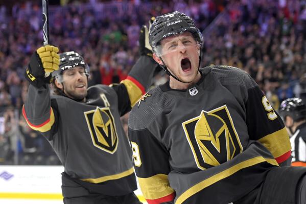Vegas Golden Knights center Jack Eichel (9) and center Chandler Stephenson (20) celebrate Eichel's power-play goal against the Nashville Predators during the second period of an NHL hockey game Thursday, March 24, 2022, in Las Vegas. (AP Photo/David Becker)