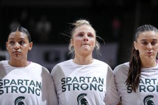 Michigan State players Moira Joiner, left, Theryn Hallock, center, and Abbey Kimball stand together before an NCAA college basketball game against Maryland, Saturday, Feb. 18, 2023, in East Lansing, Mich. (AP Photo/Al Goldis)