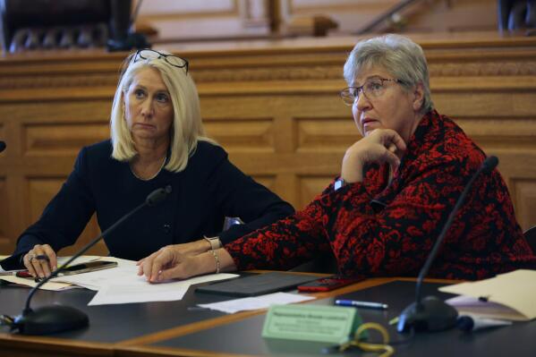 Kansas state Rep. Brenda Landwehr, R-Wichita, talks with staff as Sen. Renee Erickson, left, also R-Wichita, watches, following a legislative committee meeting about federal government vaccine mandates, Friday, Oct. 29, 2021, at the Statehouse in Topeka, Kan. Landwehr and a Wichita labor leader compared vaccine mandates to the Holocaust that killed millions of Jews during World War II. (AP Photo/Andy Tsubasa Field)