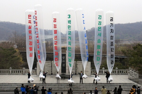 FILE - Park Sang-hak, center, a refugee from the North who runs the group Fighters for a Free North Korea from a small Seoul office, and South Korean conservative activists prepare to release balloons bearing leaflets condemning the North Korean leader during an anti-North Korea rally against the 99th anniversary of Kim Il Sung's birth, called 