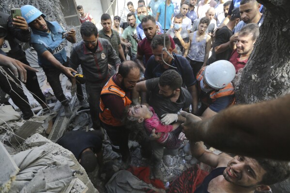 Palestinians rescue a child from under the rubble after Israeli airstrikes in Gaza City, Gaza Strip, Wednesday, Oct. 18, 2023. (AP Photo/Abed Khaled)