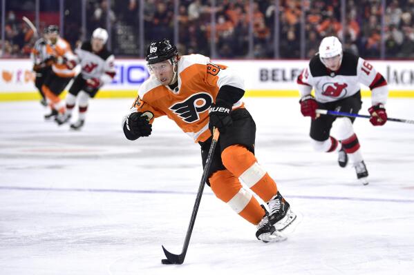 Philadelphia Flyers' Cam Atkinson skates up ice with the puck during the second period of an NHL hockey game against the New Jersey Devils, Tuesday, Dec. 14, 2021, in Philadelphia. (AP Photo/Derik Hamilton)